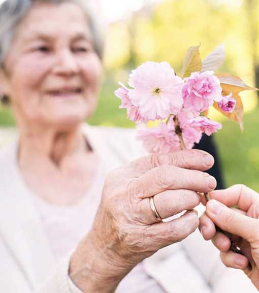 Elderly woman with flowers